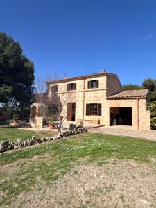a large stone house with a large yard at Son Rapinya Porto Cristo in Porto Cristo