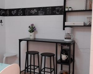 a black counter with stools in a kitchen at Solerma in Viveiro +22 photos