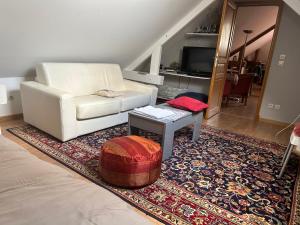 a living room with a white couch and a table at Villa grain de sel in Étaples