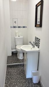 a white bathroom with a toilet and a sink at stylish new house sleeps 5 max in Swansea