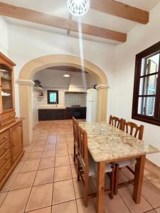 a large kitchen with a table and chairs at Son Rapinya Porto Cristo in Porto Cristo