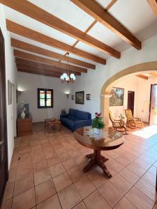 a living room with a blue couch and a table at Son Rapinya Porto Cristo in Porto Cristo