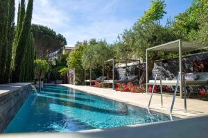 a swimming pool in a yard with a patio at Maison Pic in Valence