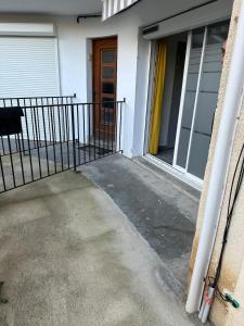 an entrance to a house with a gate and a door at BOUTON D'OR Studio Terrasse Grand Lit Coin Repas in Château-Arnoux-Saint-Auban
