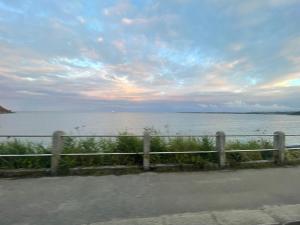 a view of a body of water with a fence at Beachfront Retreat in Falmouth