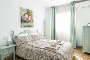 a bedroom with a bed with towels on it at Rodas Apartment in Torrevieja