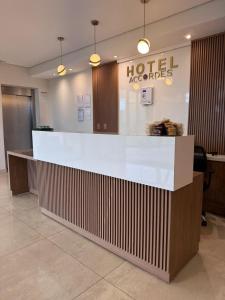 a hotel lobby with a large white counter top at Hotel Accordes in Campo Grande