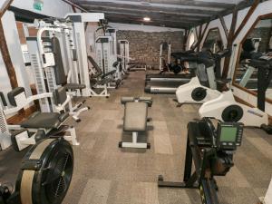 a gym with a bunch of treadmills and machines at Under Cliff Caravan in Ferryside