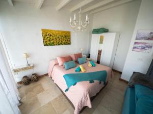 a bedroom with a large bed with a painting on the wall at El Laurel in Frontera