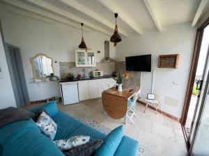 a living room with a blue couch and a kitchen at El Laurel in Frontera +10 photos