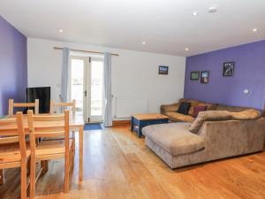 a living room with a table and a couch at Swallows Rest in Hexham