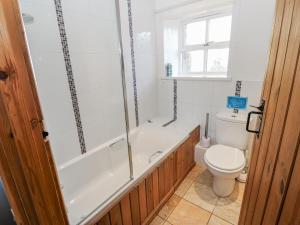 a bathroom with a tub and a toilet and a shower at Swallows Rest in Hexham +28 photos