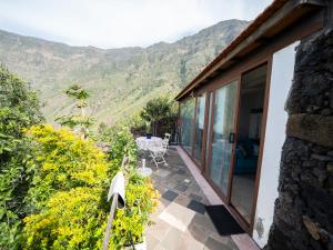 a balcony of a house with mountains in the background at El Laurel in Frontera