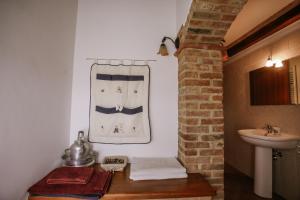 a bathroom with a sink and a toilet and a mirror at La Casa di Alice in Villa San Secondo +62 photos