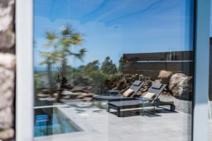 a view of a patio with two chairs and a pool at Casa Arim in Orosei