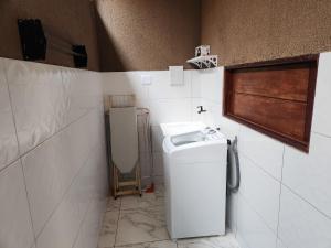 a bathroom with a toilet and a sink at Lar de verão casa 01 in Barra de São Miguel +3 photos