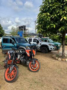 a motorcycle parked next to a group of parked cars at Finca Las Vegas in Aguazul