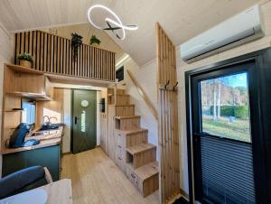 an interior view of a tiny house with a staircase at Tiny House WaldSEEle in Stuer