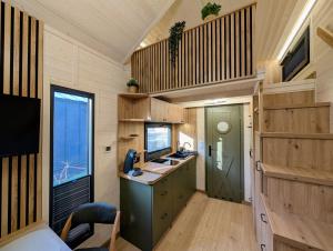 a kitchen in a tiny house with a sink at Tiny House WaldSEEle in Stuer