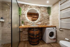 a bathroom with a sink and a washing machine at Orzechowa Ostoja noclegi Energylandia in Bachowice +51 photos