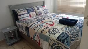 a bedroom with a bed with a quilt on it at Dadda's Place 2 in Port Shepstone +28 photos