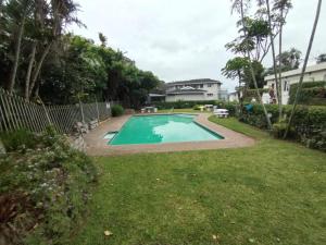 a swimming pool in the yard of a house at Dadda's Place 2 in Port Shepstone