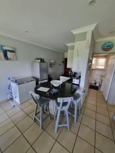 a kitchen with a table and chairs in a room at Dadda's Place 2 in Port Shepstone