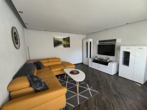a living room with a couch and a table at Leuchtturmhus in Fürstenberg