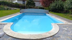 a swimming pool with blue water in a backyard at Your Perfect Escape to Relax in Sipbachzell