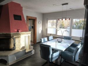 a dining room with a fireplace and a table and chairs at Leuchtturmhus in Fürstenberg