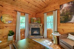 a living room with a fireplace in a log cabin at Havenridge in Logan