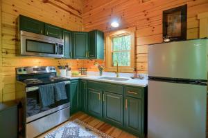 a kitchen with green cabinets and a refrigerator at Havenridge in Logan