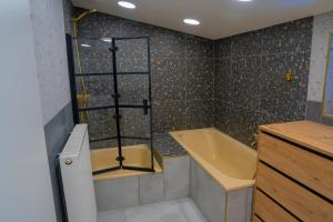 a bathroom with a shower and a tub and a sink at Berg Glück Axams in Innsbruck