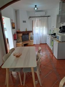 a kitchen with a table and chairs in a room at Casa Azélia e Albino in Aves