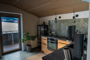 a kitchen with a sink and a stove top oven at Berg Glück Axams in Innsbruck +7 photos