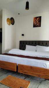 a bedroom with two beds in a room at Ashe Oleng House in Arusha