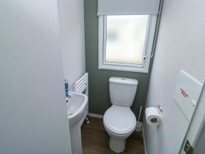 a bathroom with a toilet and a sink and a window at The Foxy Cobbler in Kingsbridge +15 photos