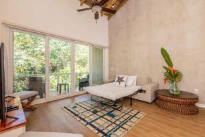 a living room with a couch and a chair at Blue Roatan Resort in West Bay