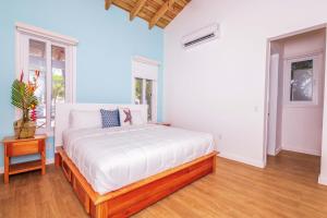 a bedroom with a large bed and a window at Blue Roatan Resort in West Bay +118 photos