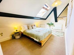 a bedroom with a king sized bed in a attic at Langdale Loft - Whitby in Whitby