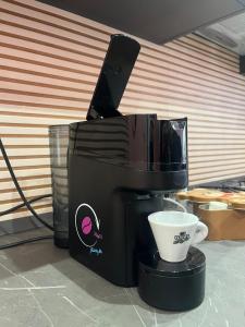 a coffee maker with a cup on top of it at Marilù Accoglienza del Sud in Foggia