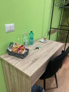 a table with a basket of fruit and water bottles at Marilù Accoglienza del Sud in Foggia +14 photos