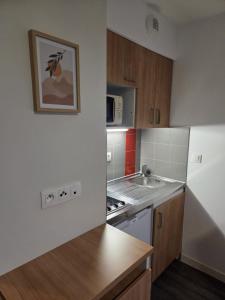 a kitchen with a sink and a stove top oven at Amour x Paris x Netflix x Wheel chair Access in Ivry-sur-Seine