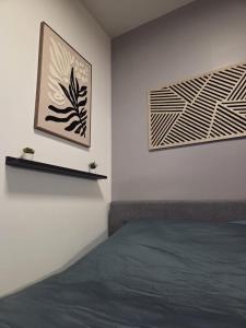 a bedroom with a bed and two pictures on the wall at Amour x Paris x Netflix x Wheel chair Access in Ivry-sur-Seine
