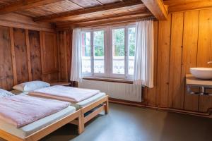 a bedroom with two beds and a window at Beinwil am See Youth Hostel in Beinwil