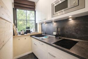a kitchen with a sink and a stove in it at Chalet Jägerstieg in Braunlage