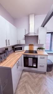 a kitchen with white cabinets and a stove top oven at Grant House in Boston +13 photos