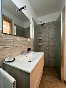 a bathroom with a sink and a mirror at Tina House in Siculiana