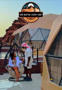a couple of people standing in a swing at RUM MARTiN BUBBLES lUXURY CAMP in Wadi Rum