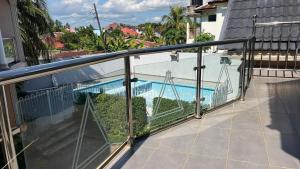 a balcony with a view of a swimming pool at skyport villa in Zanzibar City